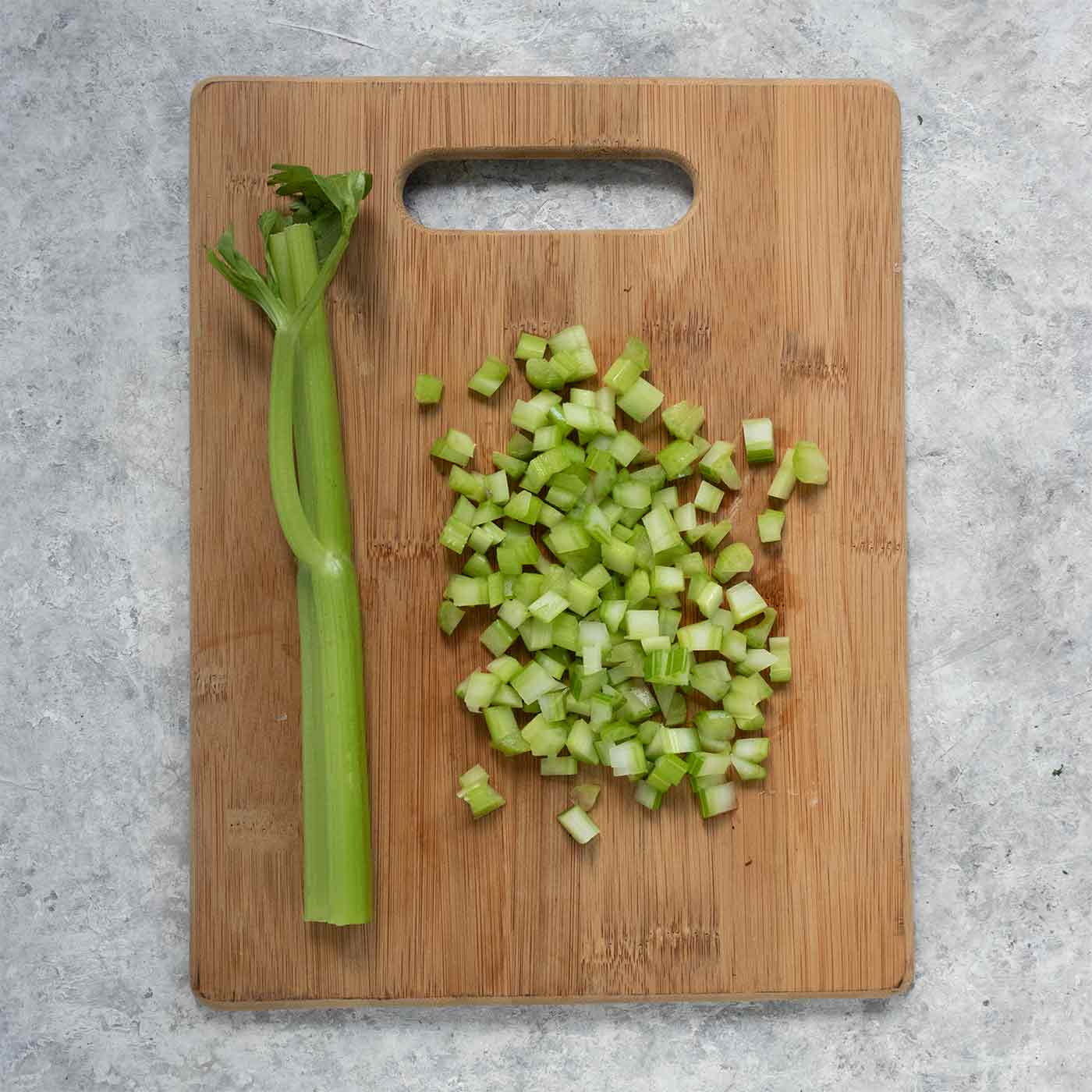Celery on a wooden cutting board.