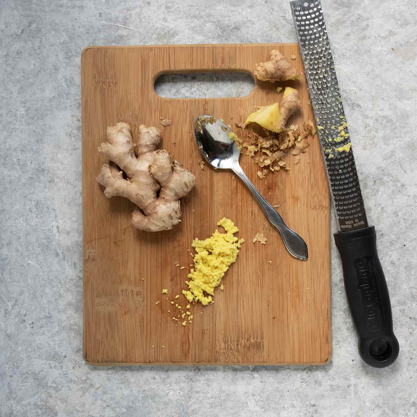 Minced ginger on a cutting board.