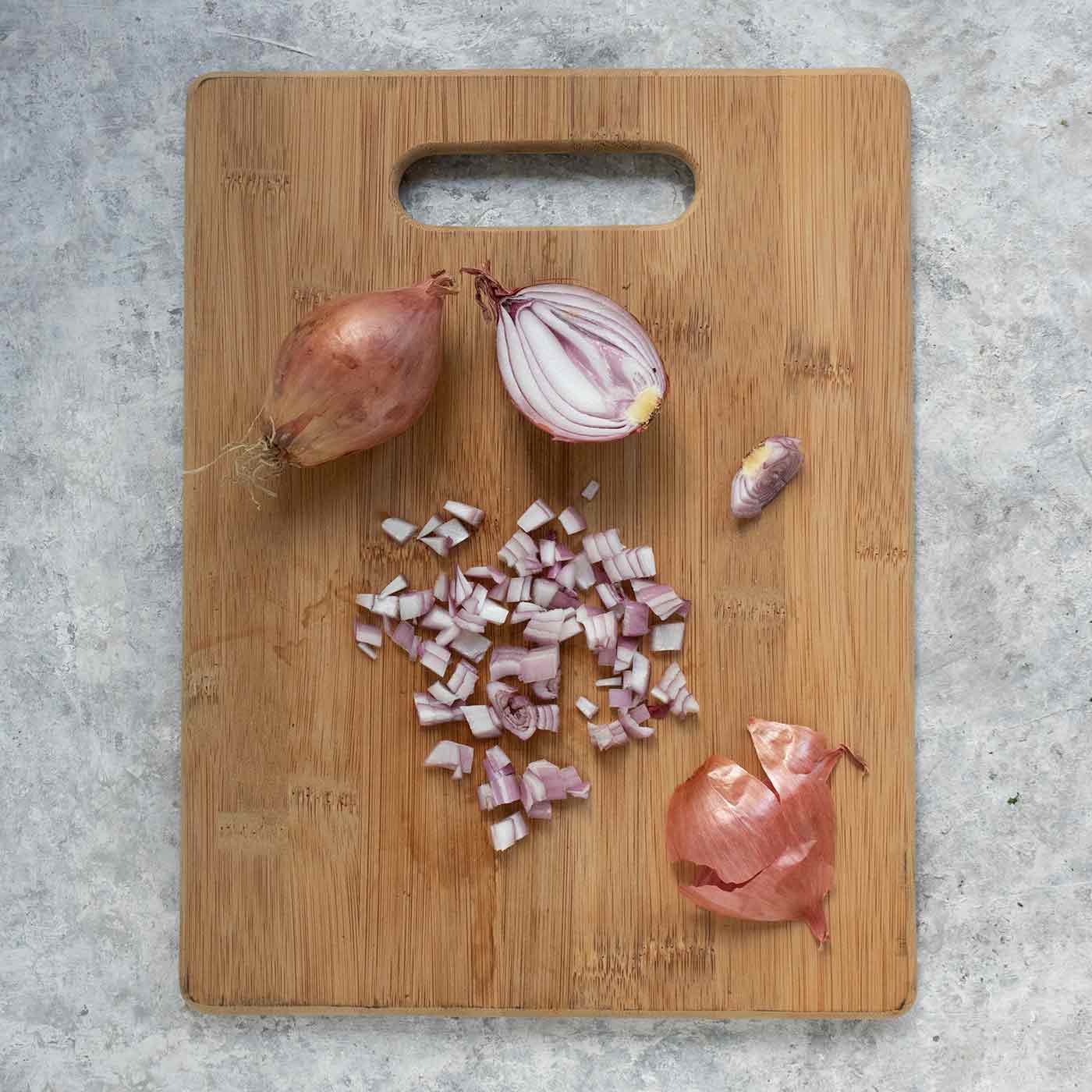 Diced shallots on a cutting board.