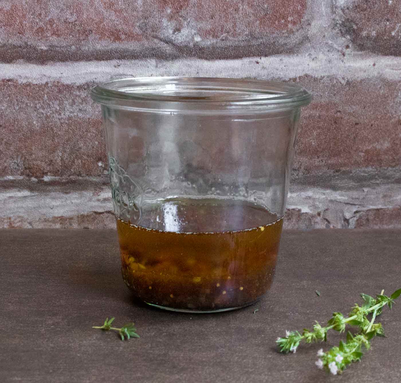 Warm Bacon Balsamic Fig Vinaigrette in a glass jar.