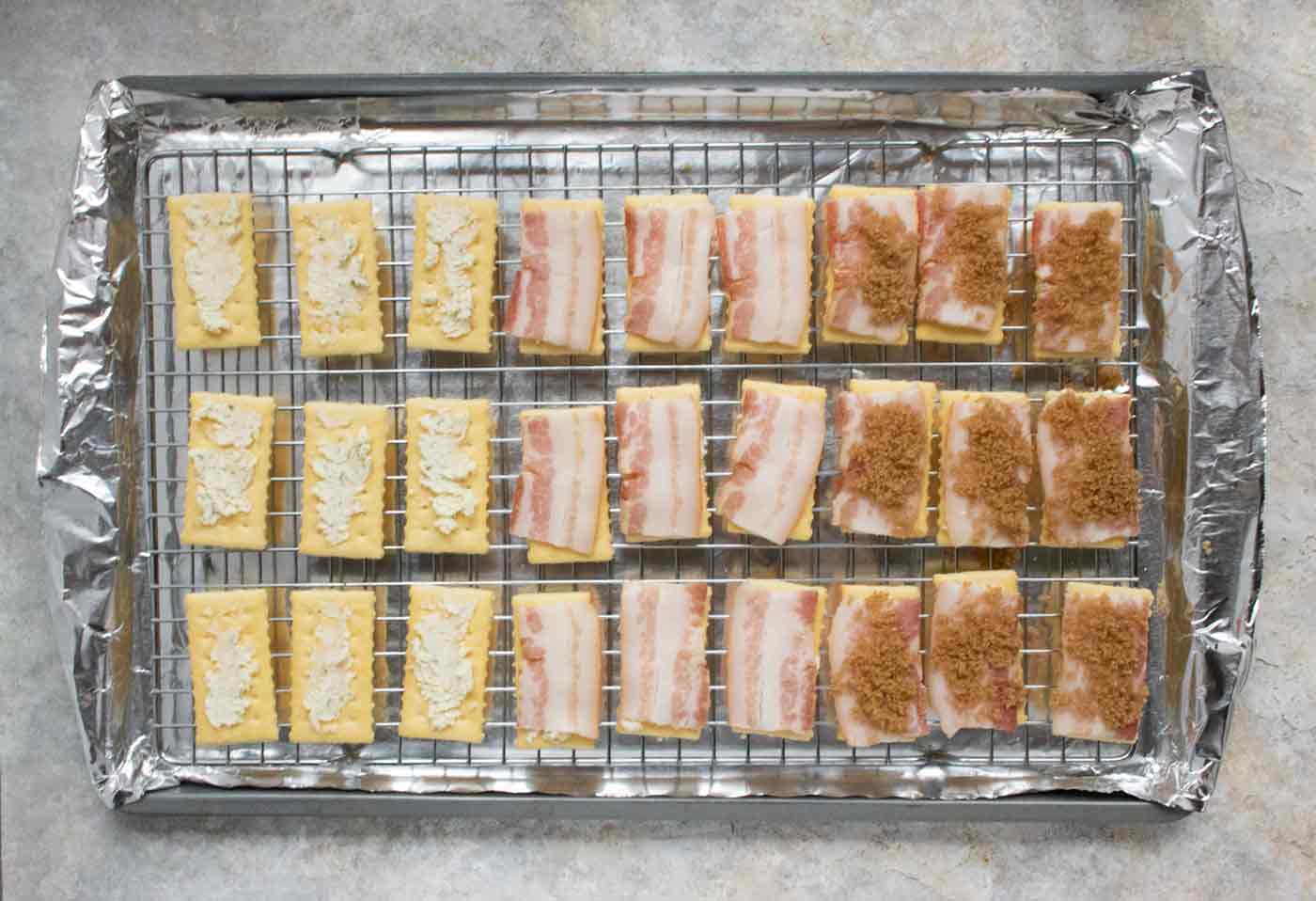 Crackers being topped with their toppings.