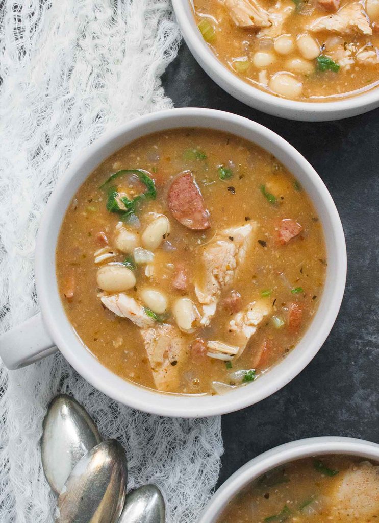 A light grey bowl of Turkey White Bean Soup.
