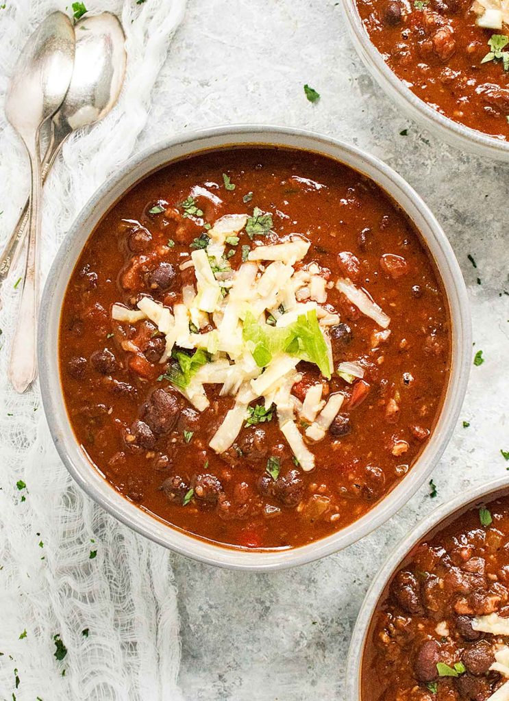A gray bowl filled with BBQ Black Bean Soup.