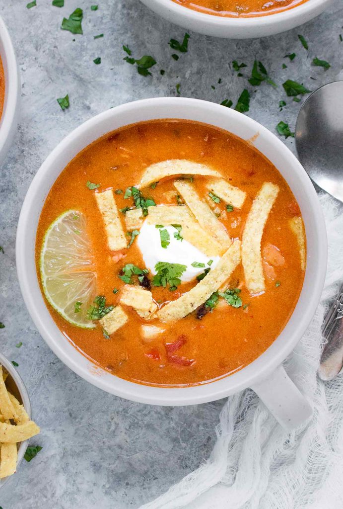 A light grey mug filled with Instant Pot Chicken Tortilla Soup.