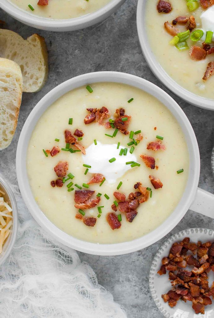 A light grey mug of Instant Pot Loaded Potato Soup.