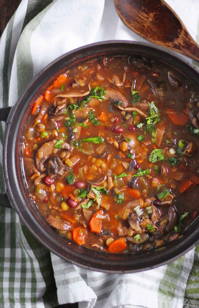 A black Dutch oven with Mushroom Lentil Adzuki Bean Soup