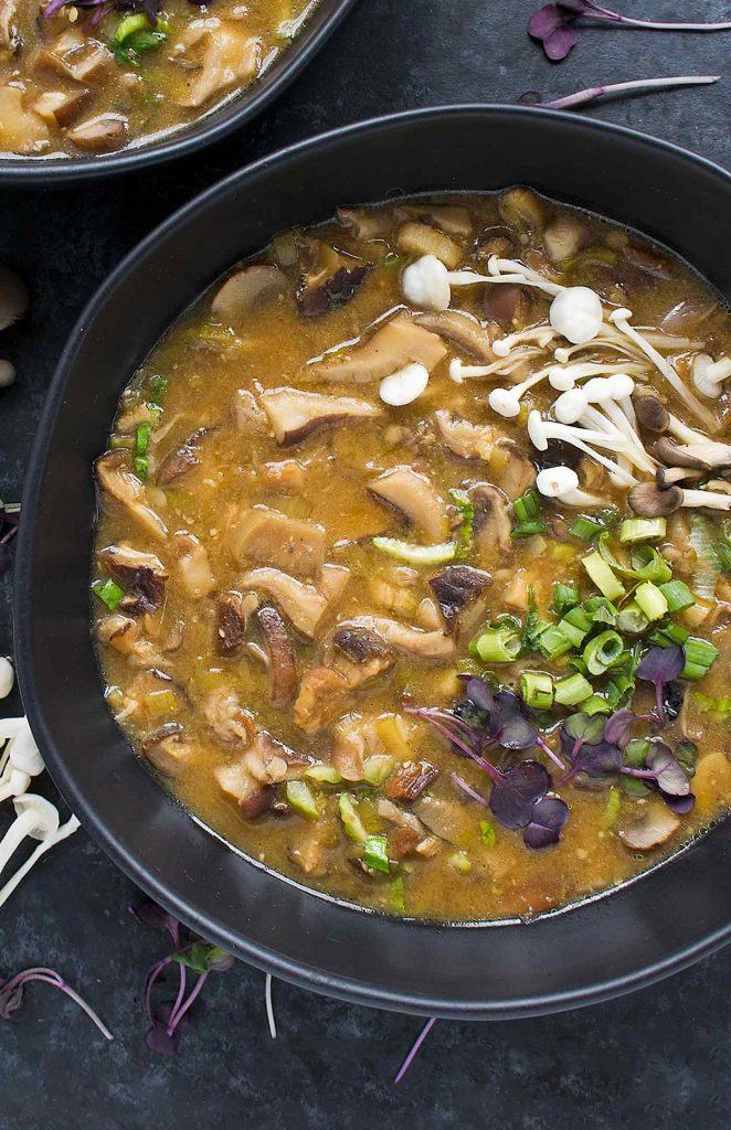 A black bowl of Detox Wild Mushroom Miso Soup.