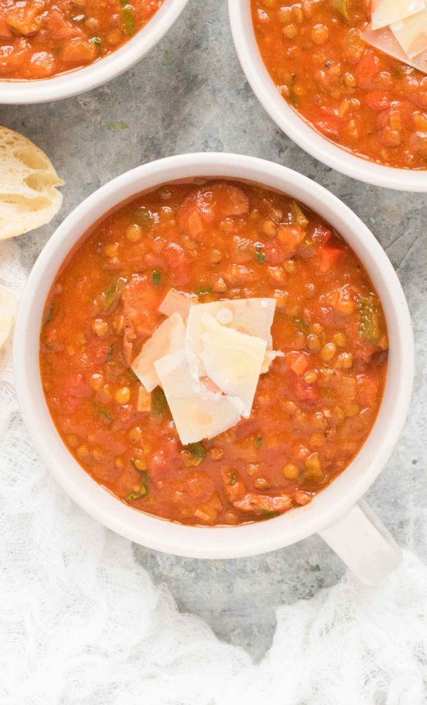 A light grey mug of Creole Lentil Soup.