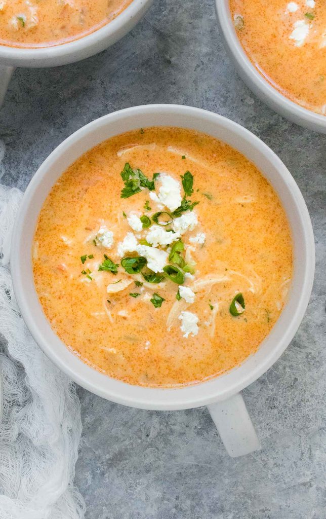 A light grey mug of Buffalo Blue Cheese Chicken Soup.