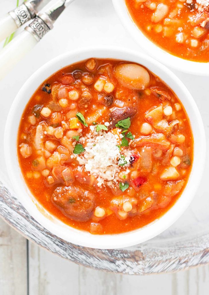 A white soup bowl filled with Sardinian Longevity Minestrone