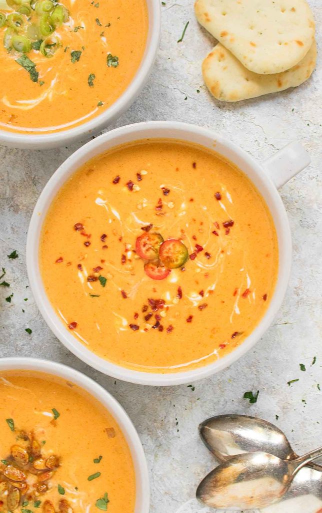 A white soup bowl with Thai Pumpkin Soup.