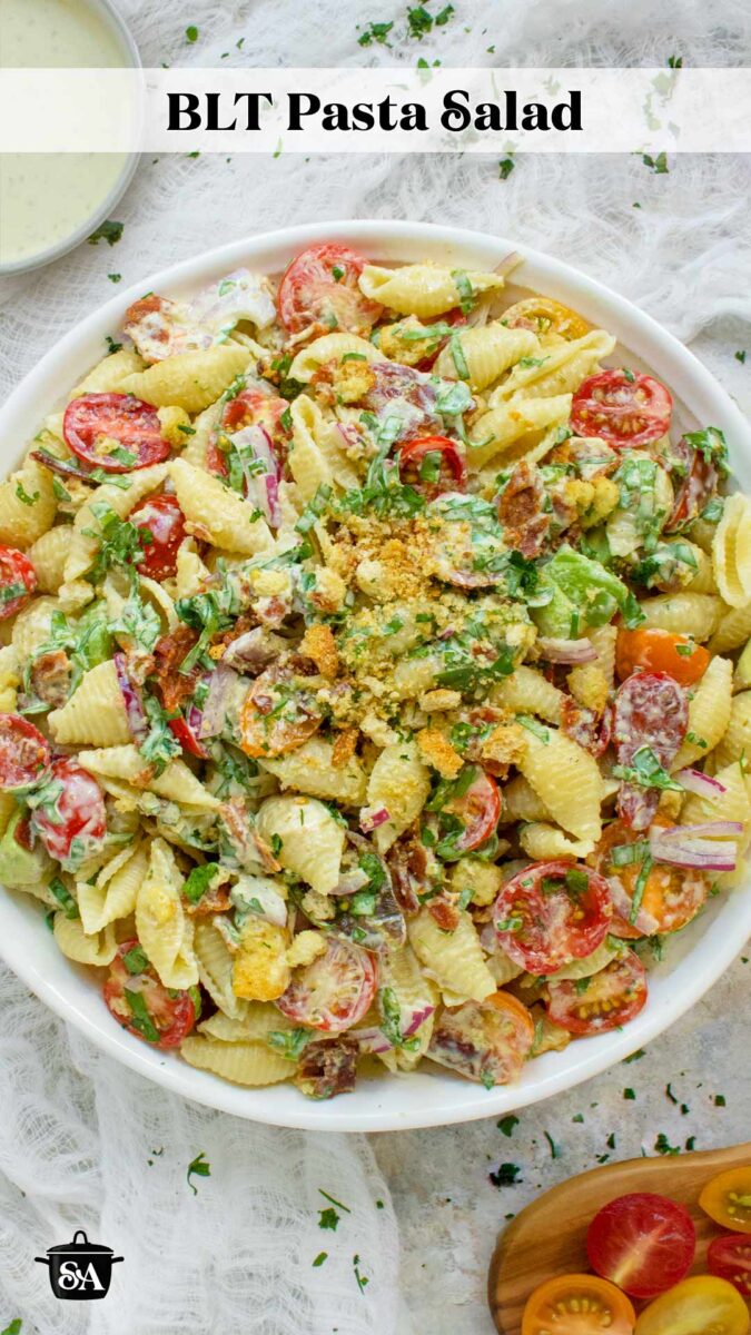 Pinterest pin image for a recipe for BLT Pasta Salad. Overhead view of a bowl of the pasta.