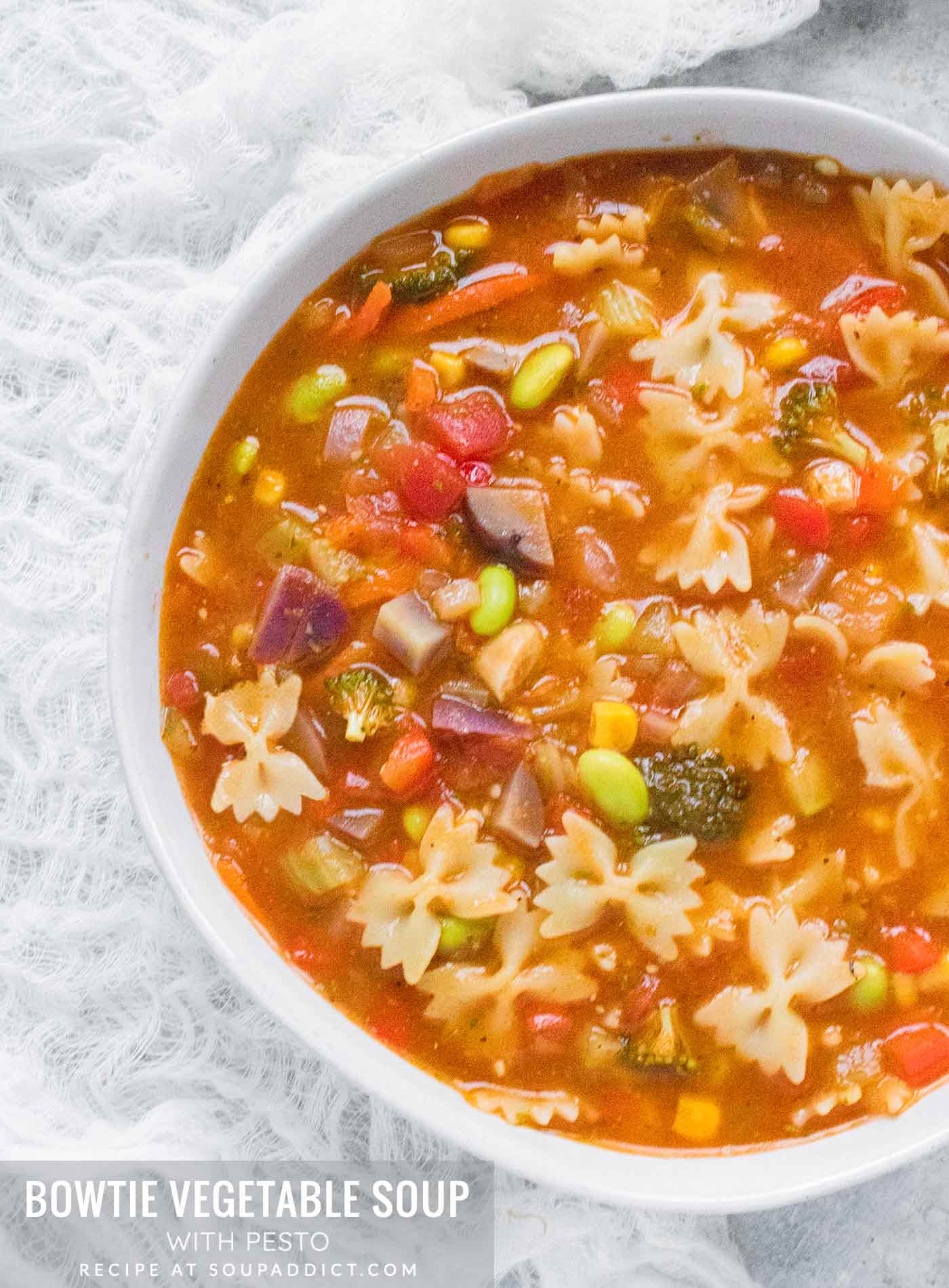 Close up of a bowl of Bowtie Vegetable Soup in a white bowl