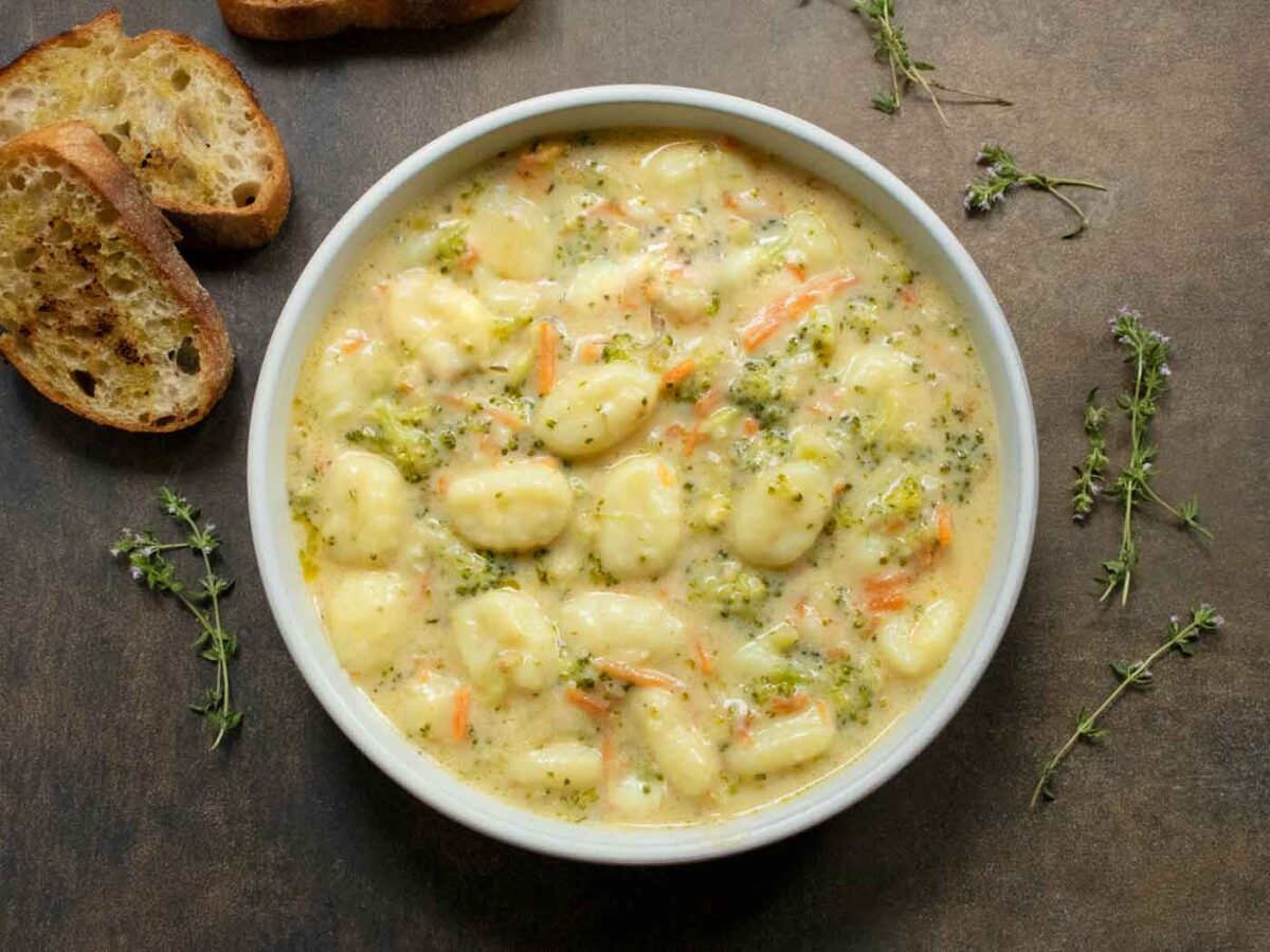 Overhead view of a bowl of Broccoli Cheddar Gnocchi Soup.