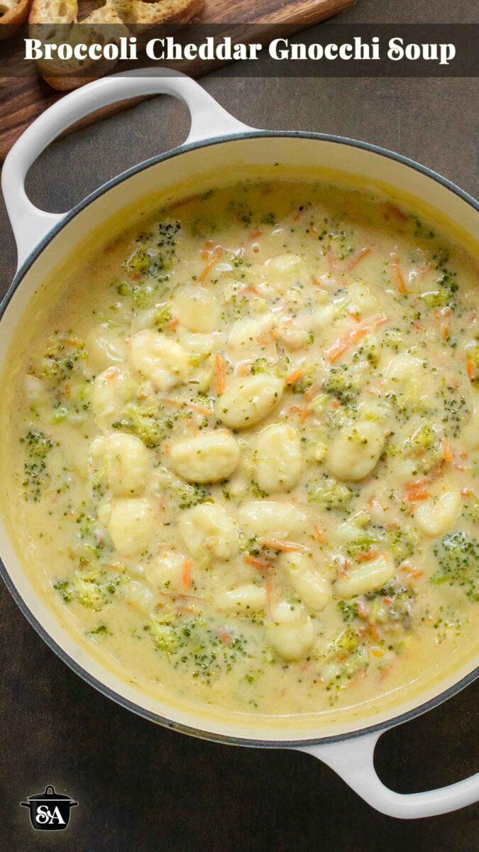 Pinterest pin image for a recipe for Broccoli Cheddar Gnocchi Soup, featuring the soup in a large white Dutch oven.