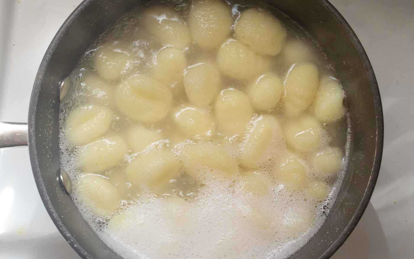 Potato gnocchi gently cooking in boiling water.
