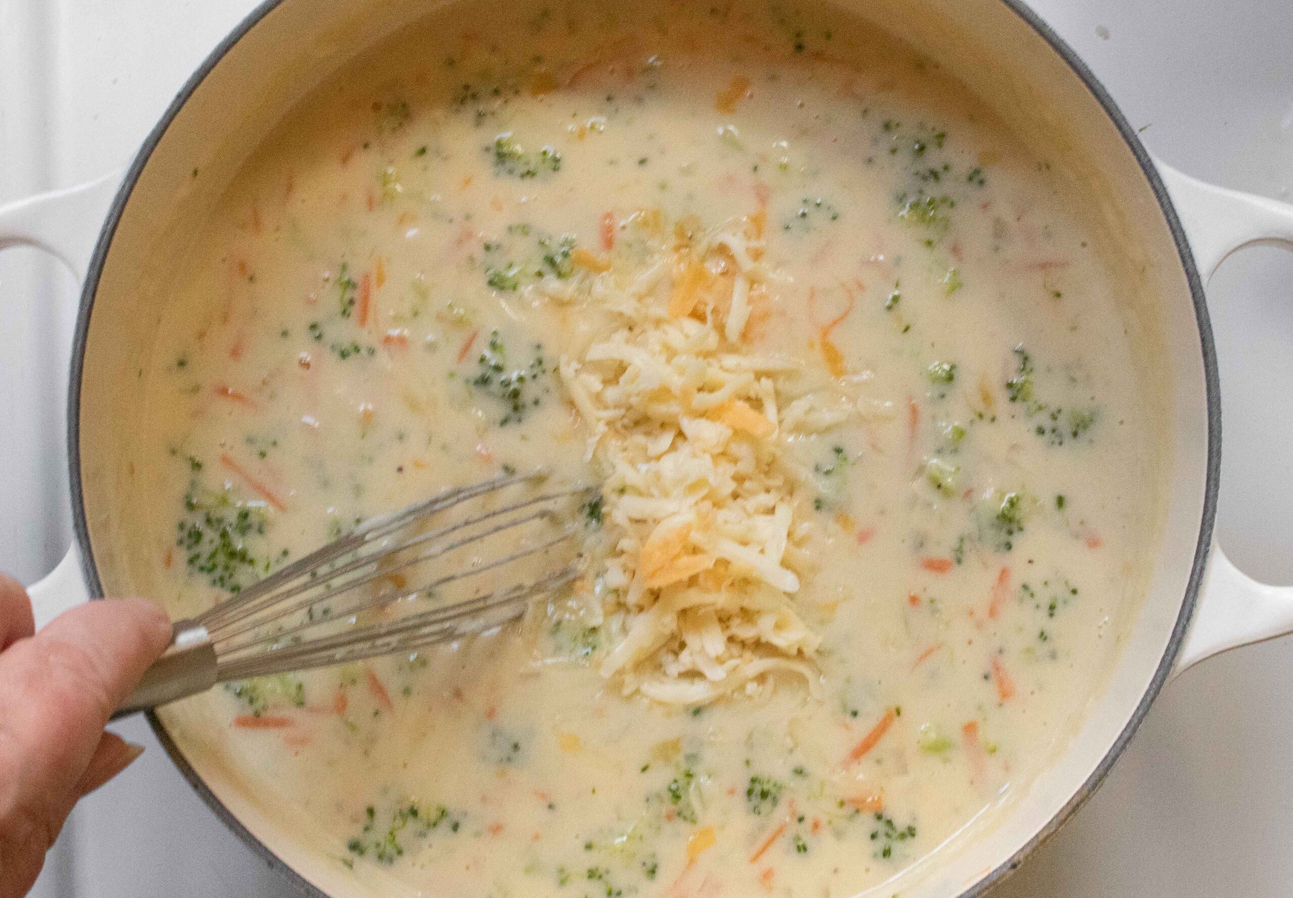Stirring the grated cheese into the soup - the best part.