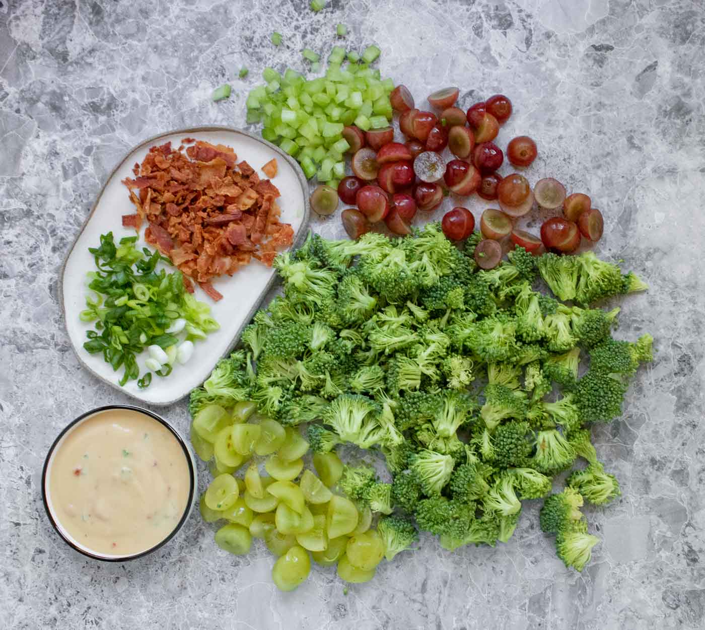 The ingredients for the salad spread out on a board.