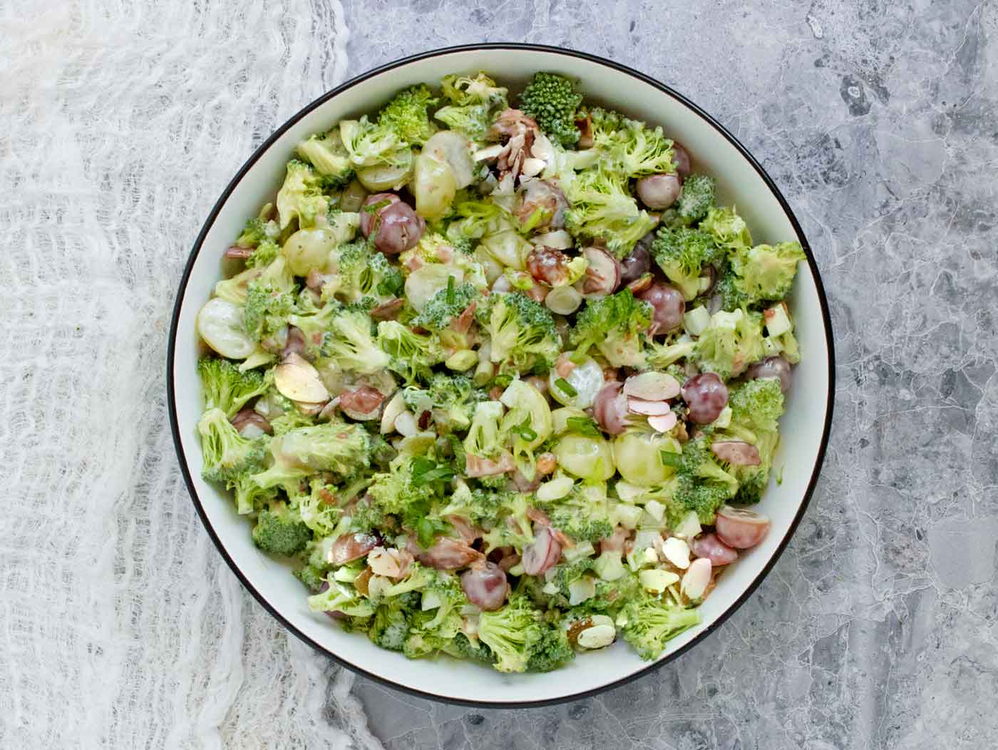 The finished salad in a white bowl with black trim.