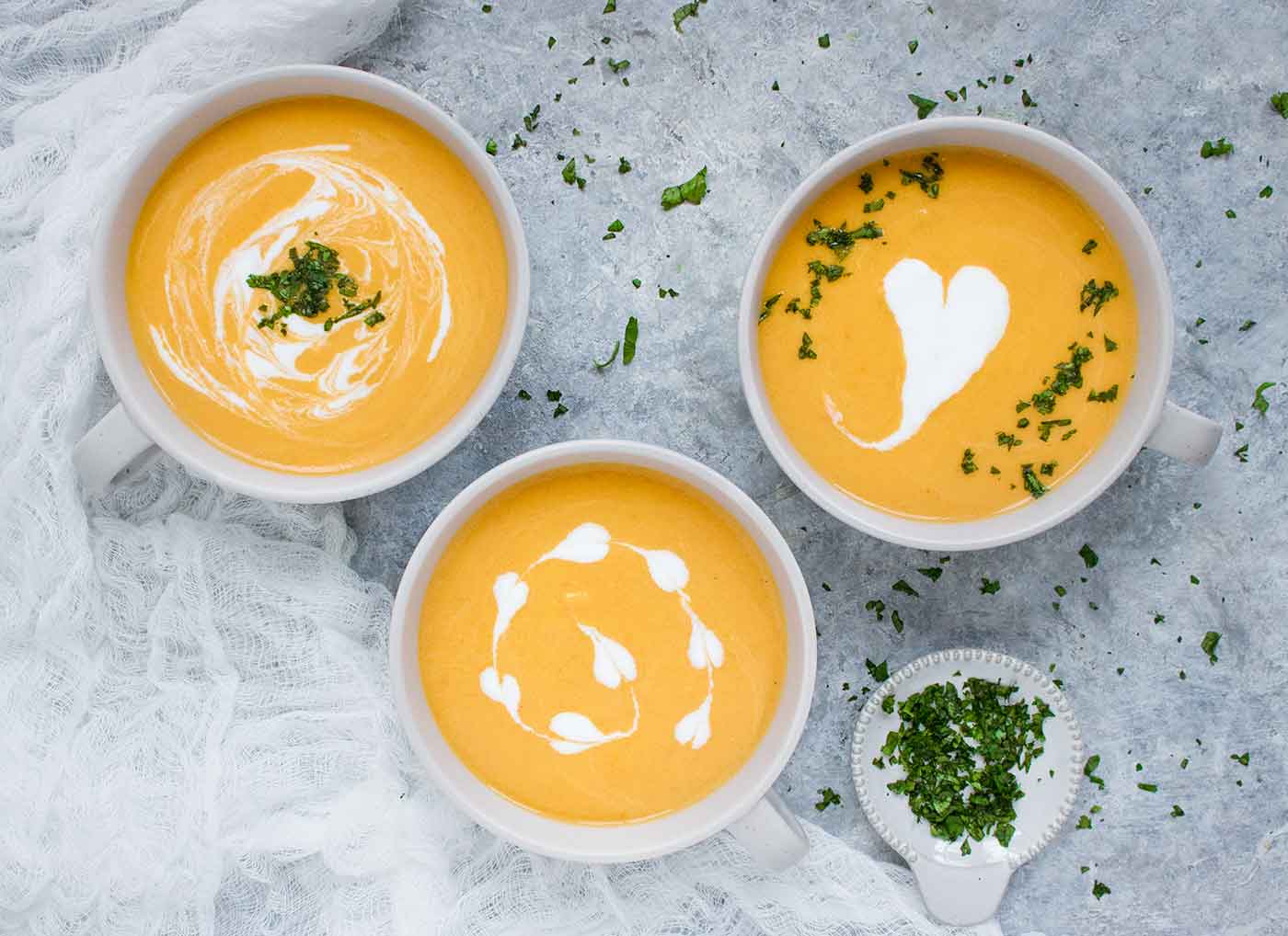 Three bowls of Carrot Lemongrass Soup, made in the Instant Pot