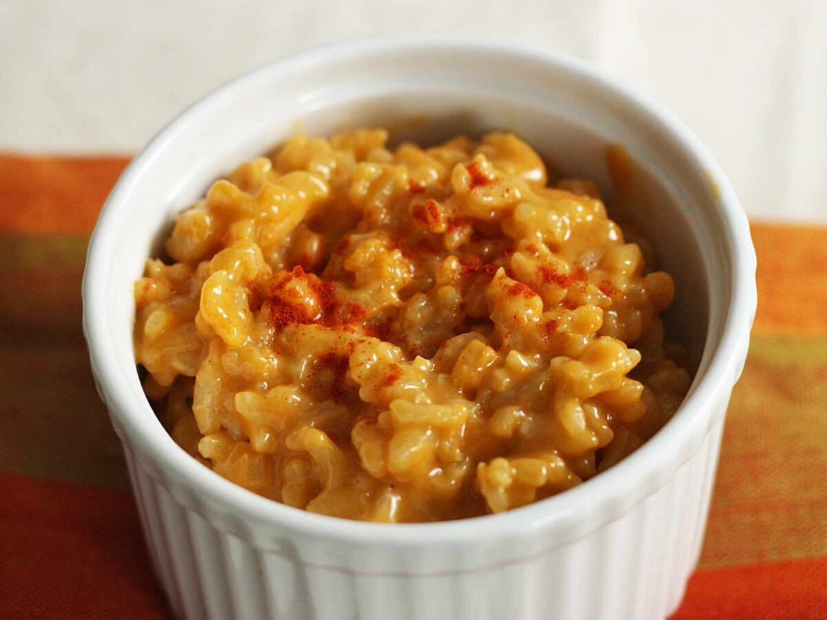 Side-angled view of Cheddar Risotto in a large white ramekin.