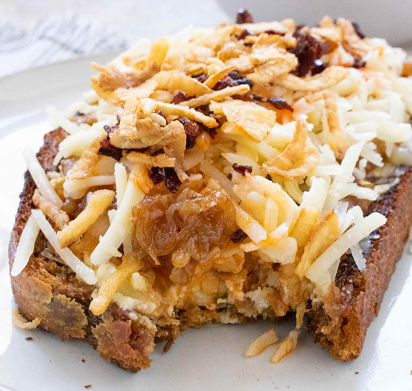 Close up of a cross-section view of one Cheesy French Onion Fried Toast.