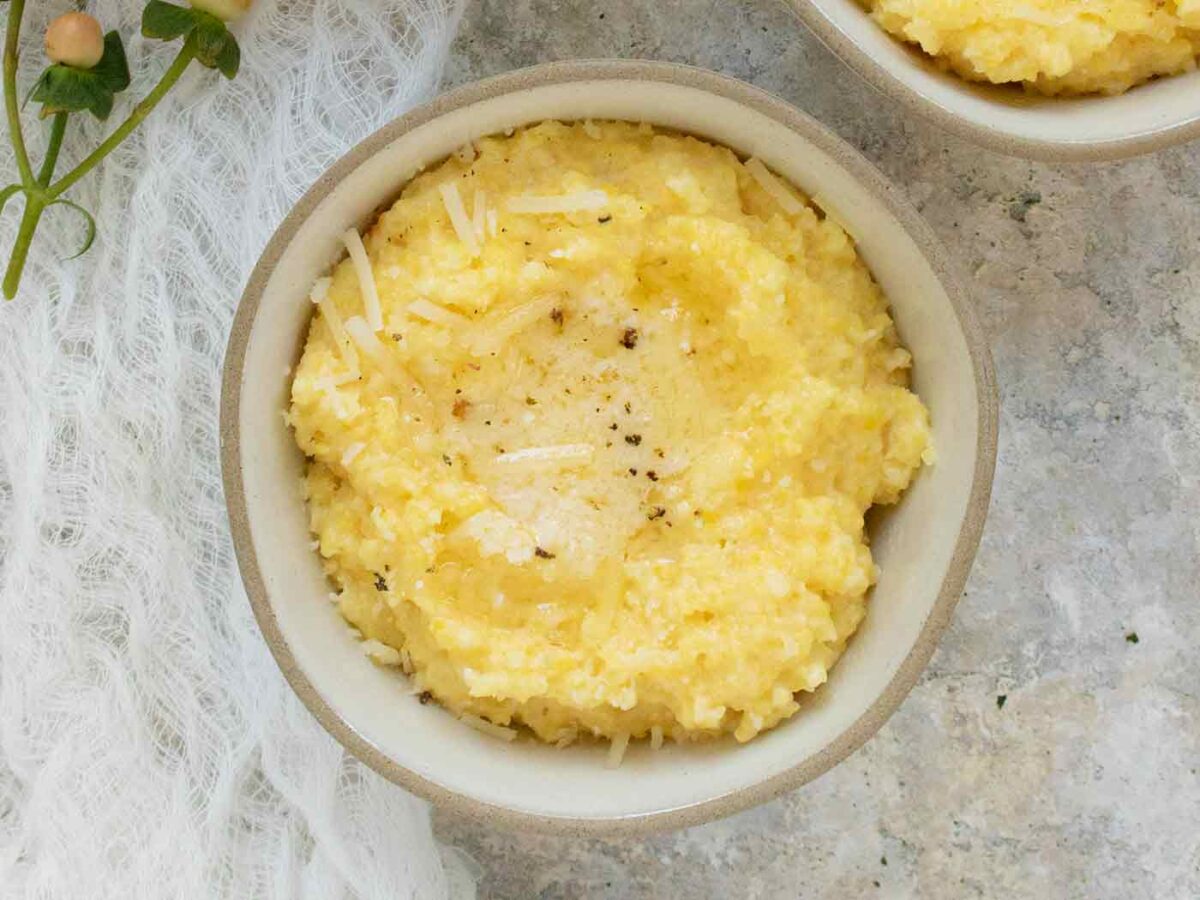 A bowl of Cheesy Grits topped with butter.