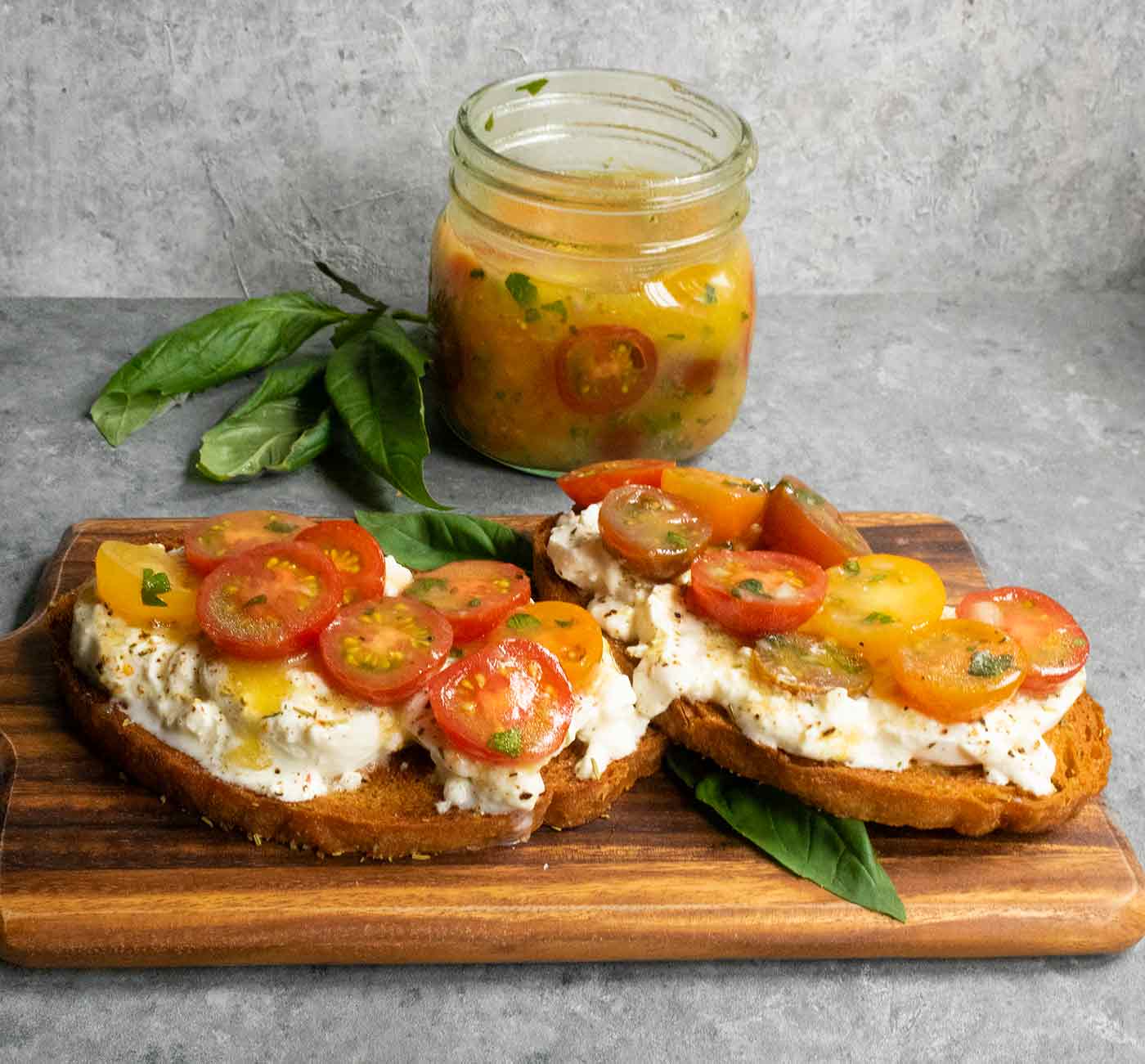 Tomato bruschetta on a bread board.