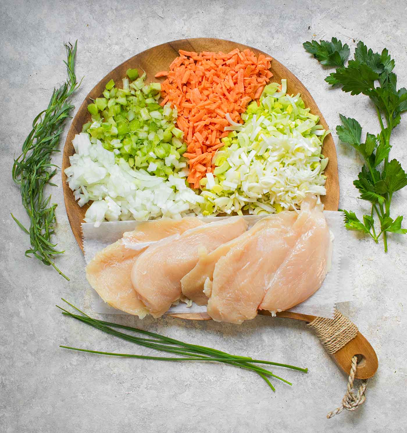 Ingredients for Chicken and Dumplings on a wooden cutting board