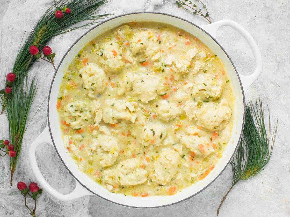 Chicken and Dumplings in a large white Dutch oven.