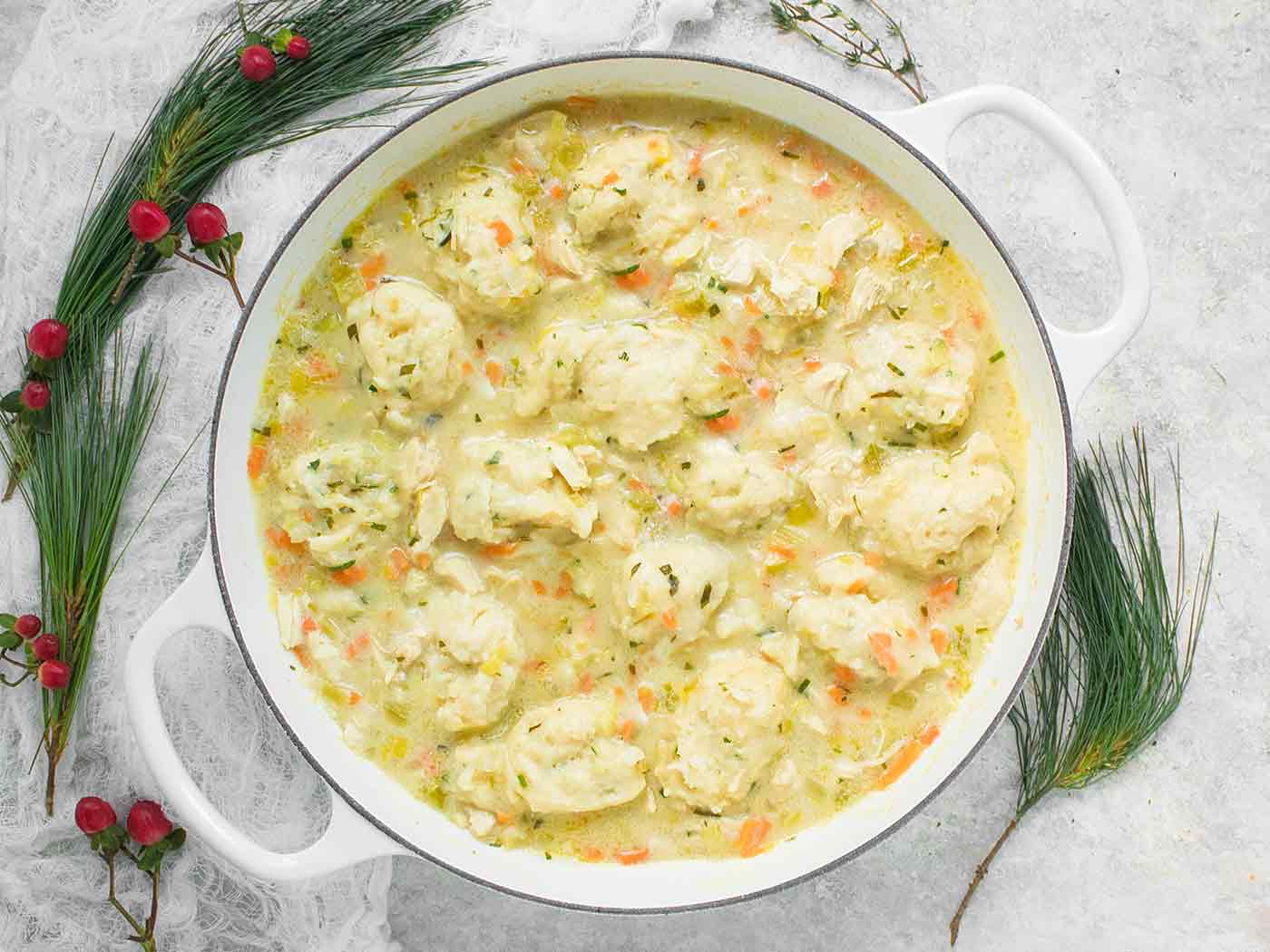 Chicken and Dumplings in a large white Dutch oven.