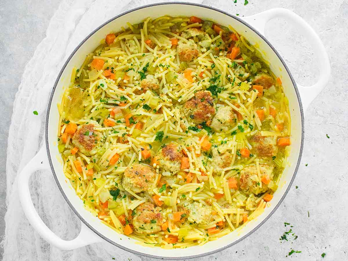 Chicken Meatball Noodle Soup in a white Dutch oven.