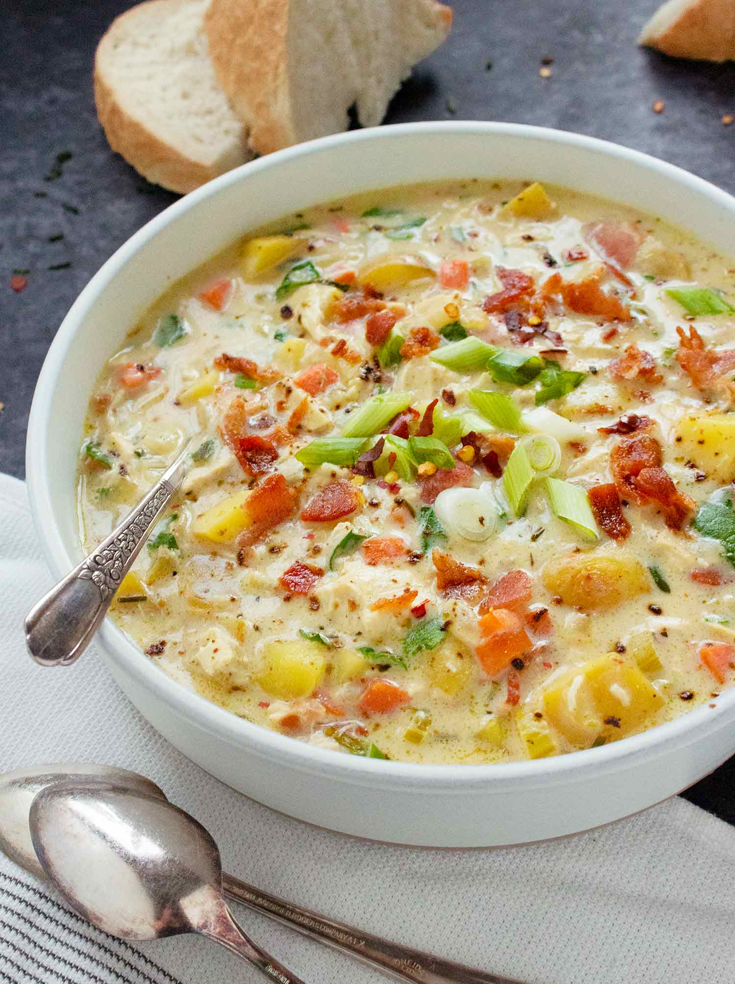 Angled view of a bowl of Chicken Potato Soup.
