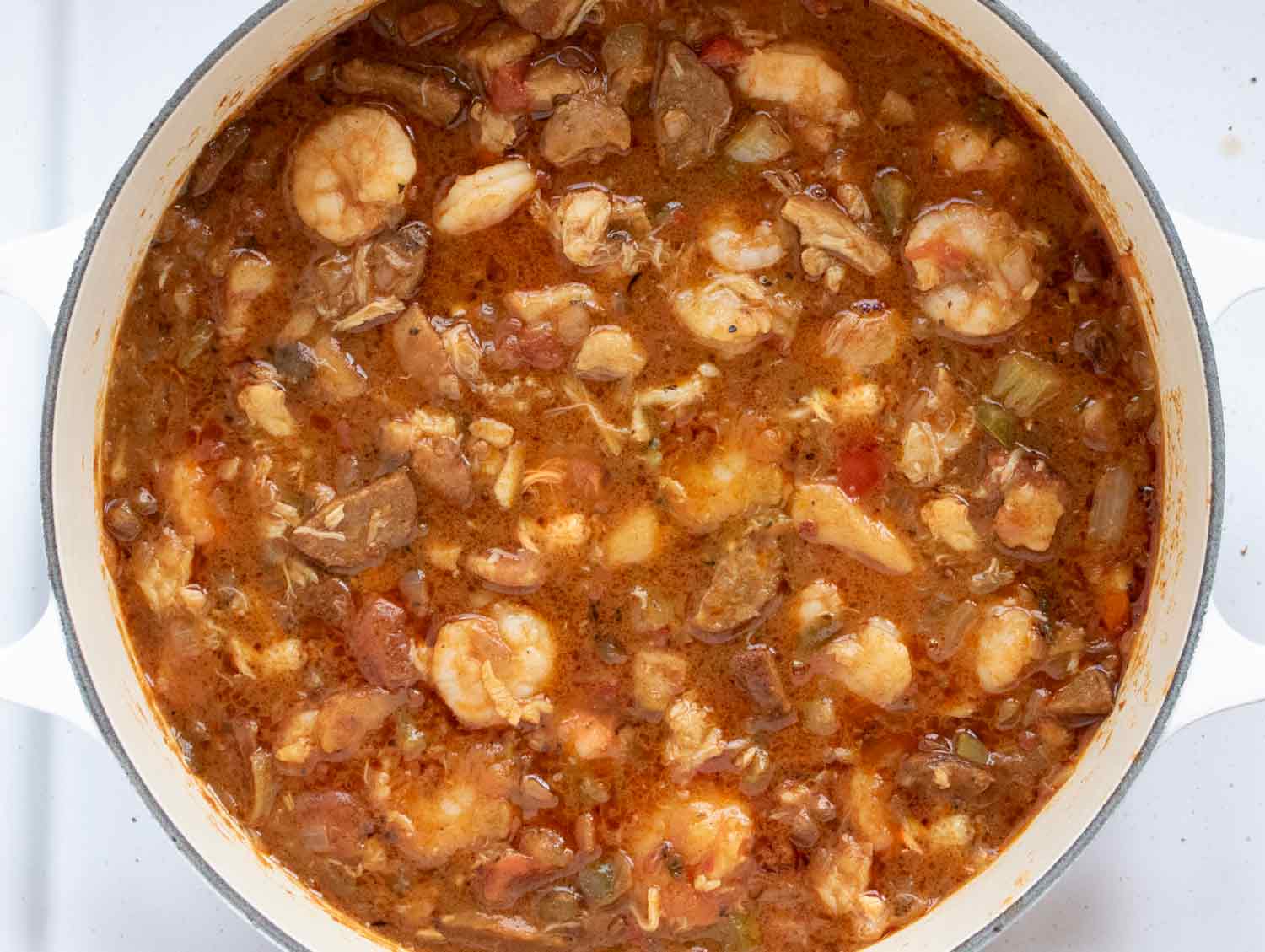 Step 4: Adding the seafood to cook through over gentle heat.
