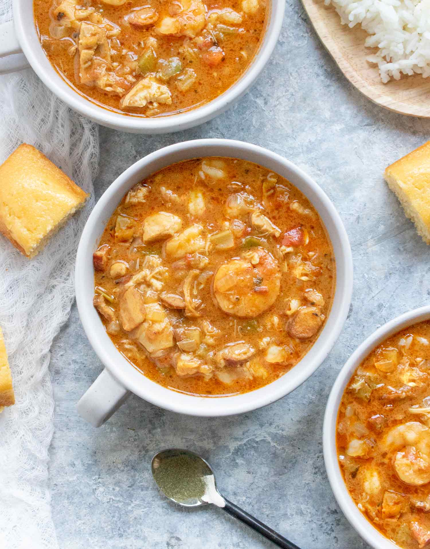Three bowls of Chicken Seafood & Sausage Gumbo with rice, ready to eat!