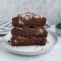 Three Chocolate Marshmallow Shortbread Bars stacked on a plate