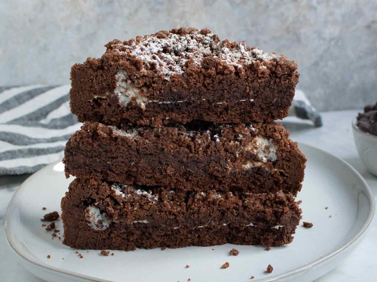 Chocolate Marshmallow Shortbread Bars stacked on a plate.