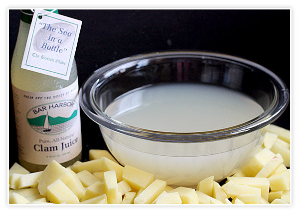 A bowl of clam juice and chopped gold potatoes