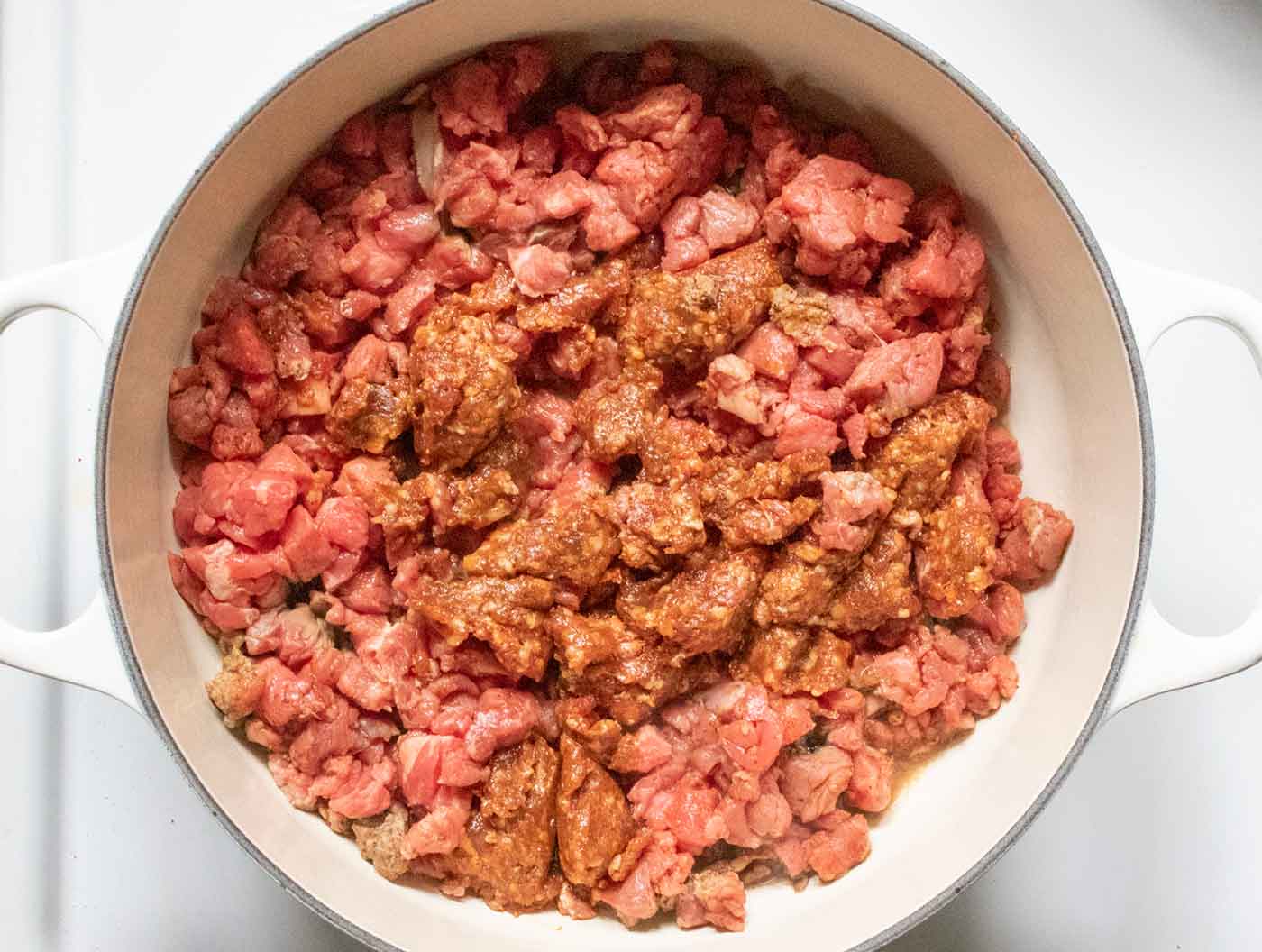 Step 1: browning the meat in a large Dutch oven.