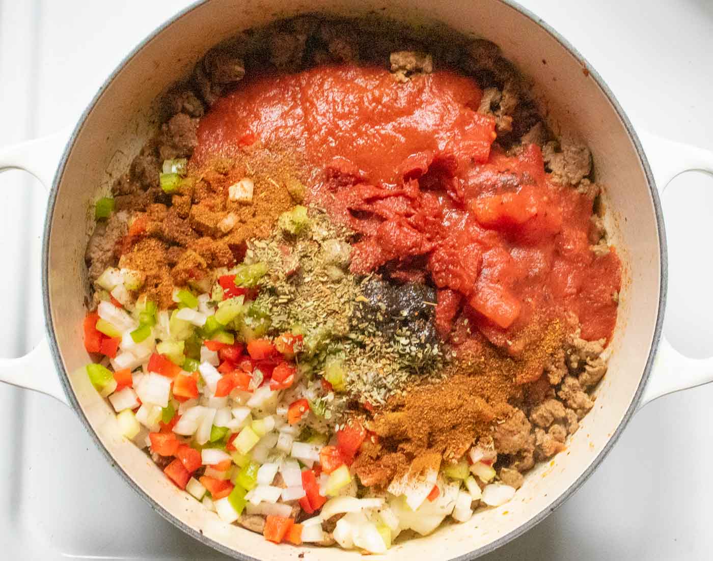 Step 2: Adding the aromatics and spices to the meat.