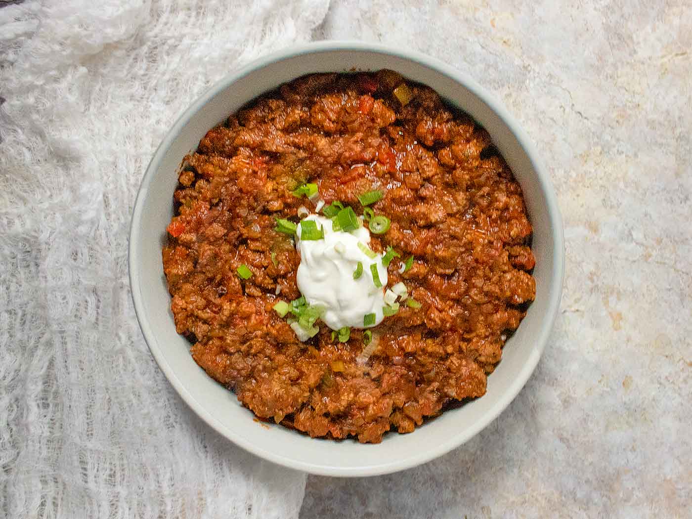 Overhead view of Classic Beef Chili in a light gray bowl.