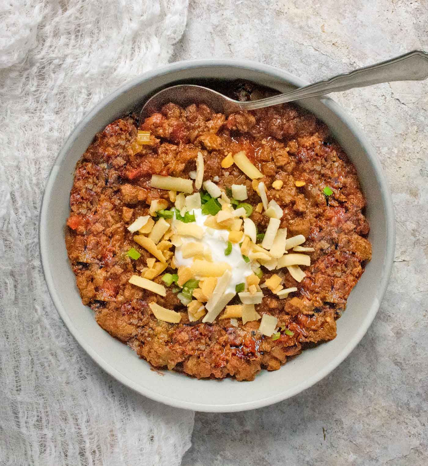 Overhead view of a bowl of Classic Beef Chili with a spoon.