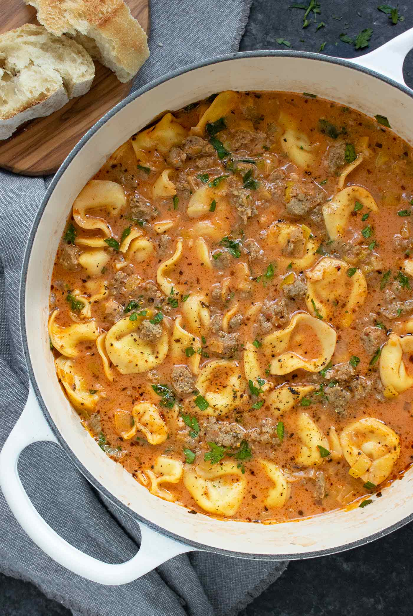 Creamy Tortellini Soup in a white Dutch oven.