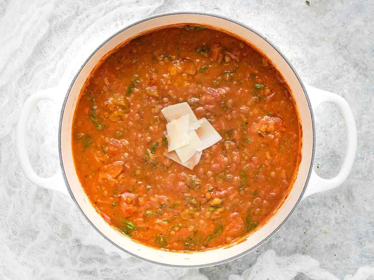 A view from above of Creole Lentil Soup in a large white Dutch oven.