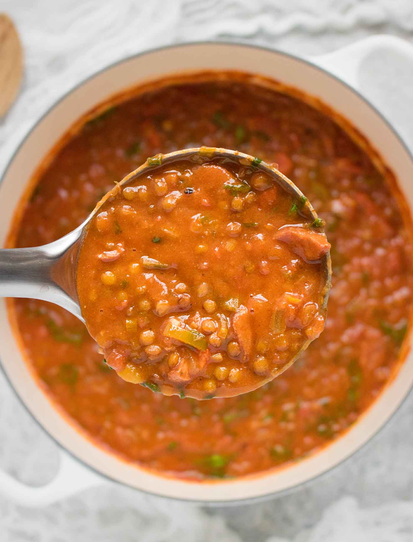 A ladle of Creole Lentil Soup