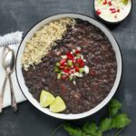 Cuban Black Bean Soup in a white bowl with a black rim.