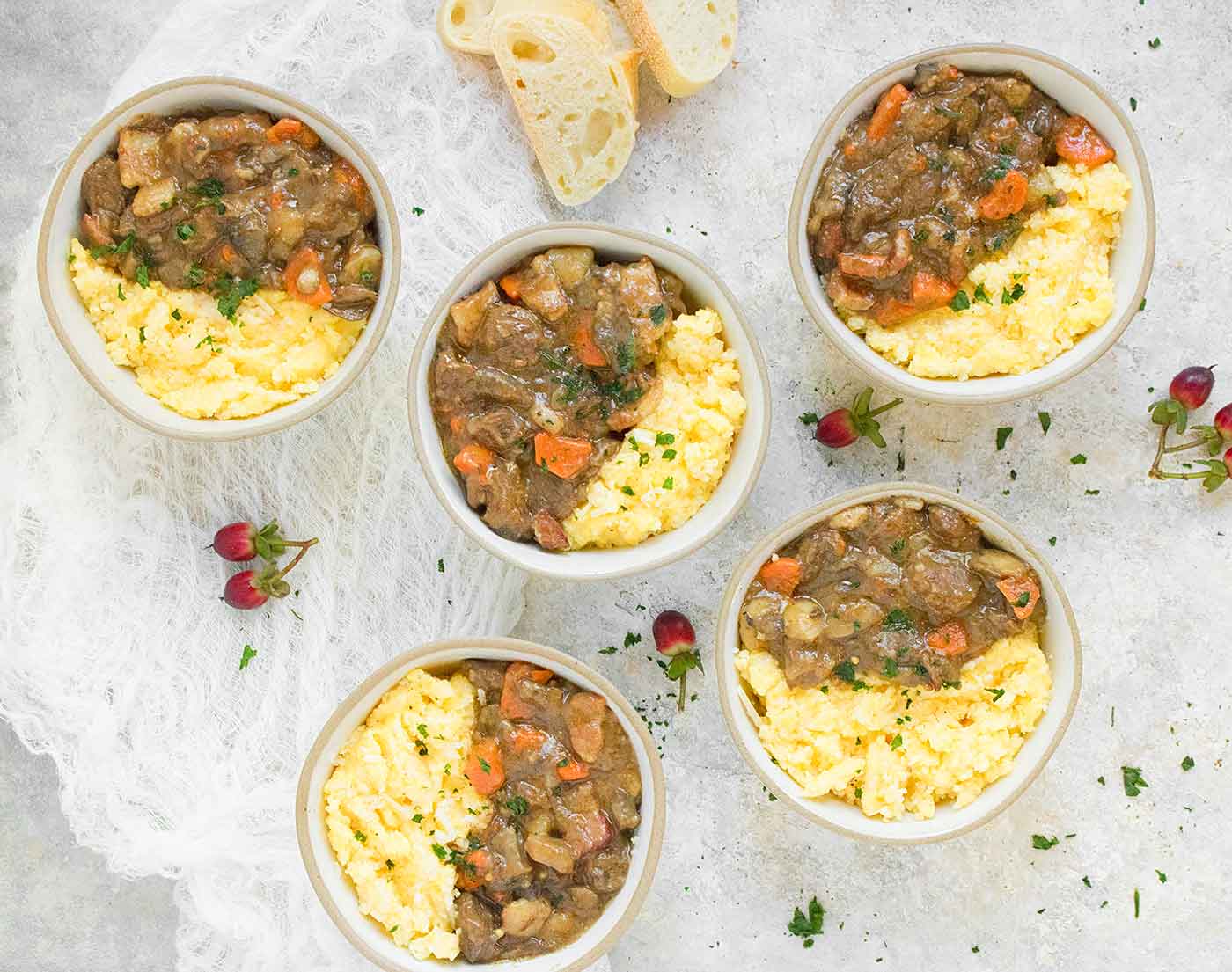 Five bowls of Dijon Beef Stew with Cheese Grits