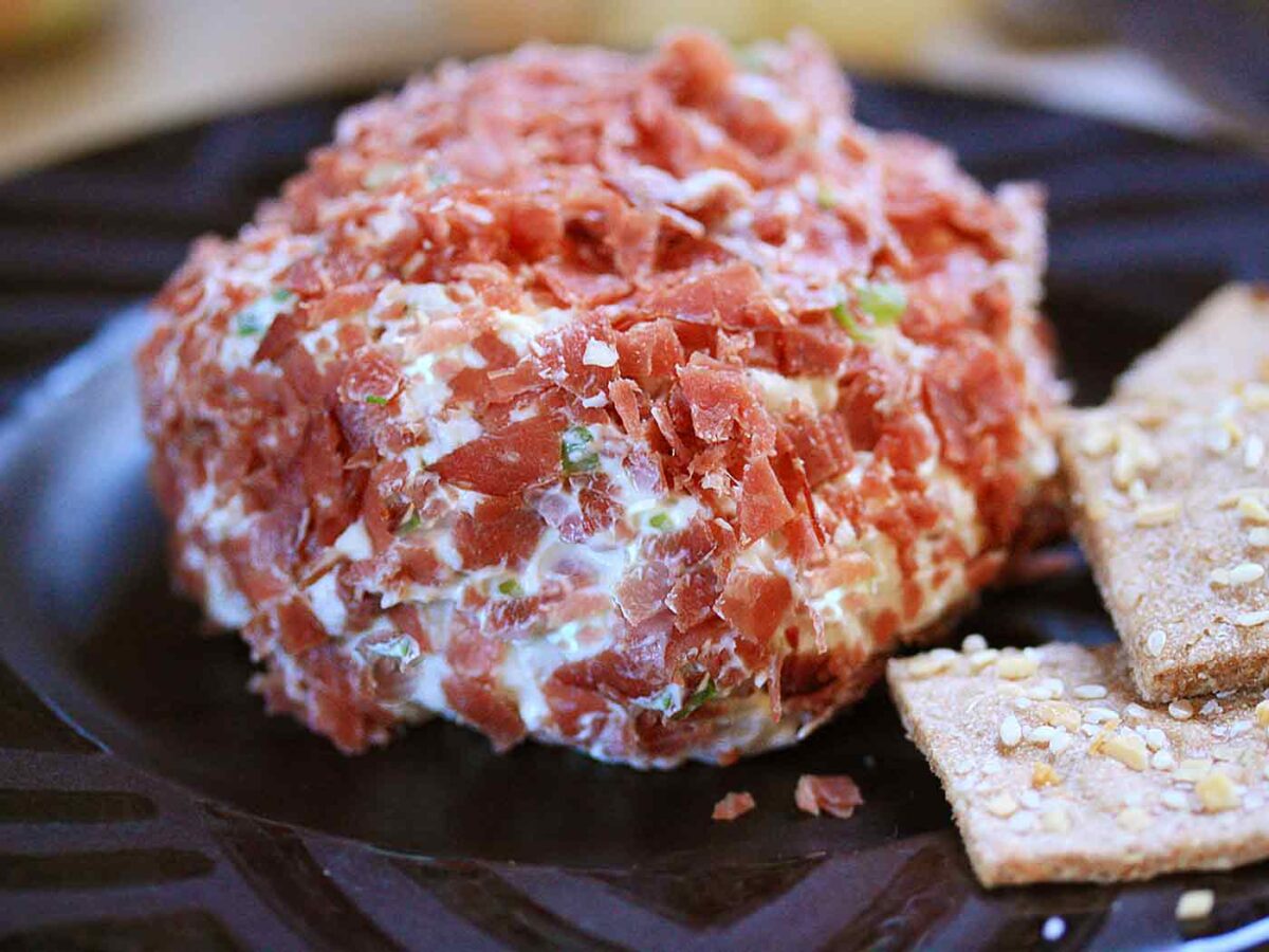 Dried Beef Cheese Ball on a plate plate with crackers.