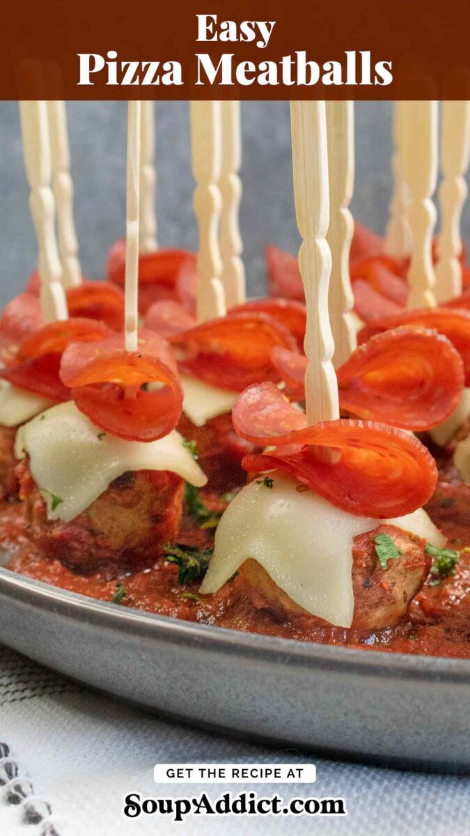 Side view of Pizza Meatballs on a dark gray plate.