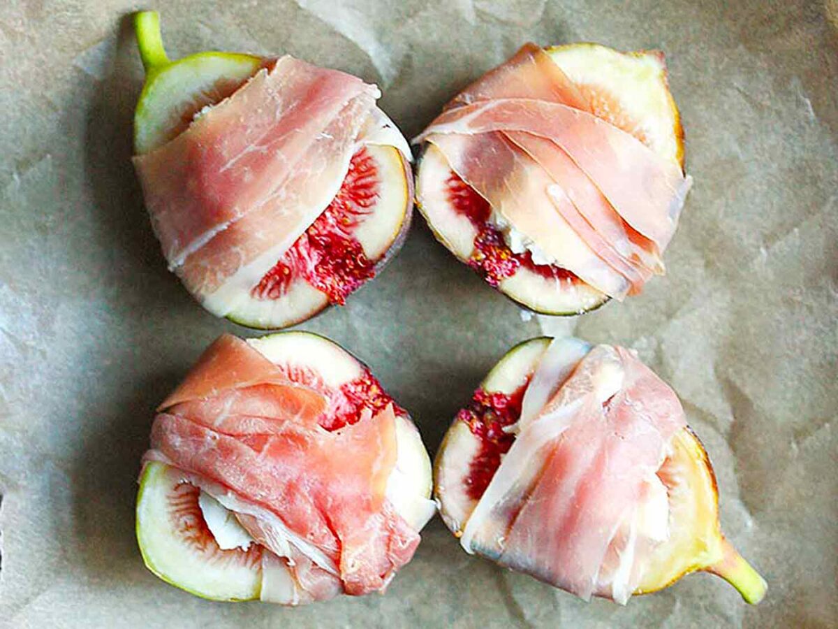 Four Figs Prosciutto on parchment paper, ready to be baked.